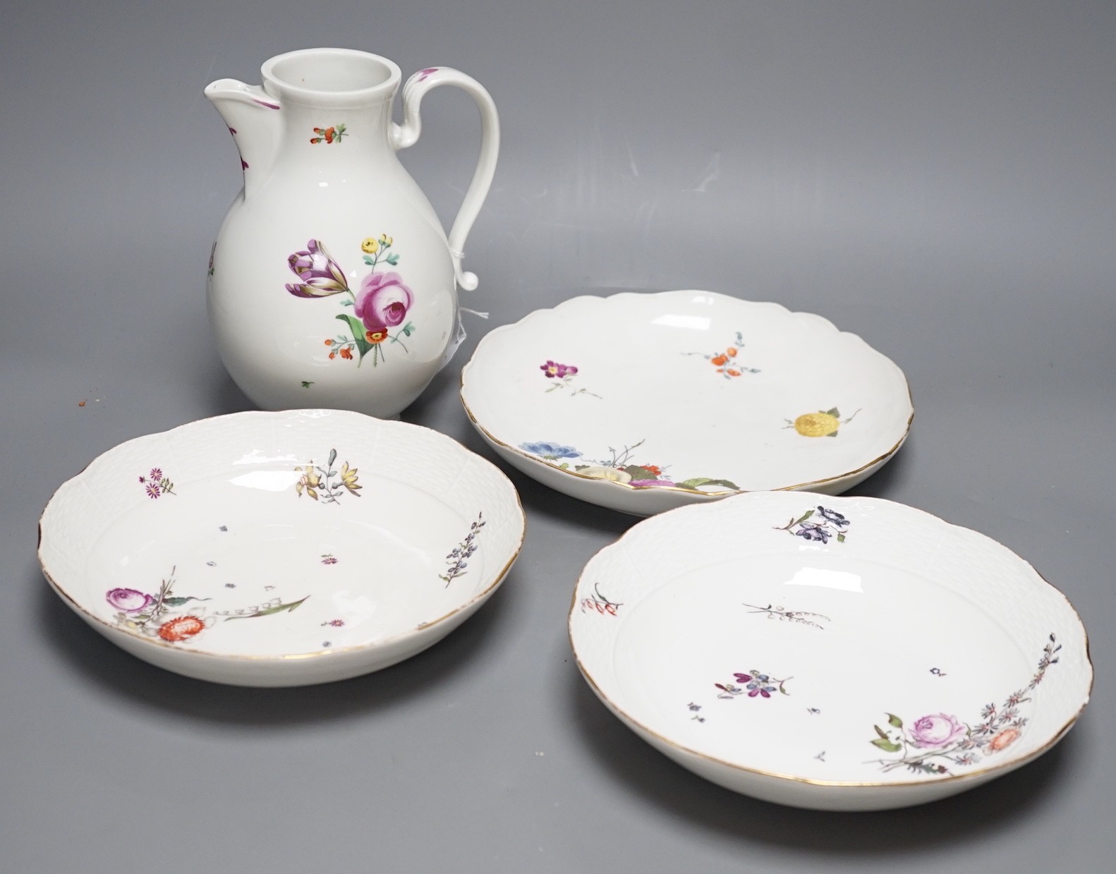 A group of three 18th century Meissen flower painted dishes and a similar late 18th century Vienna ewer, 20cm tall